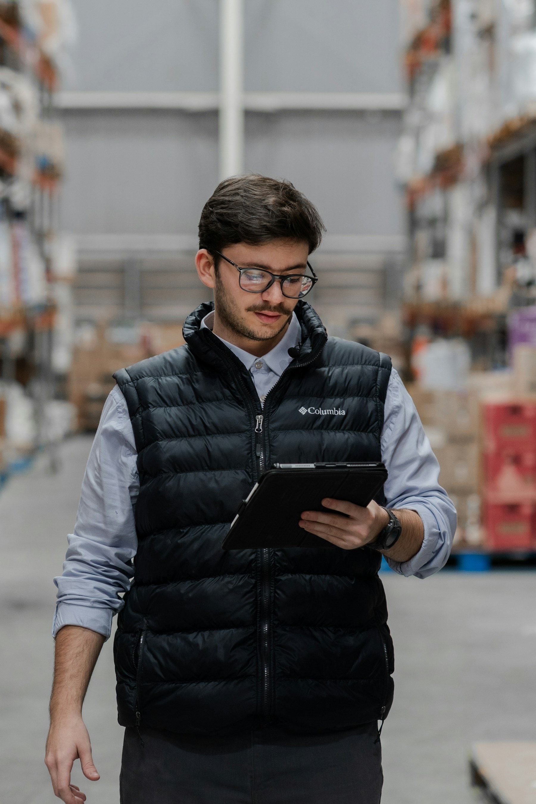 Warehouse buyer reviewing purchasing work on a tablet
