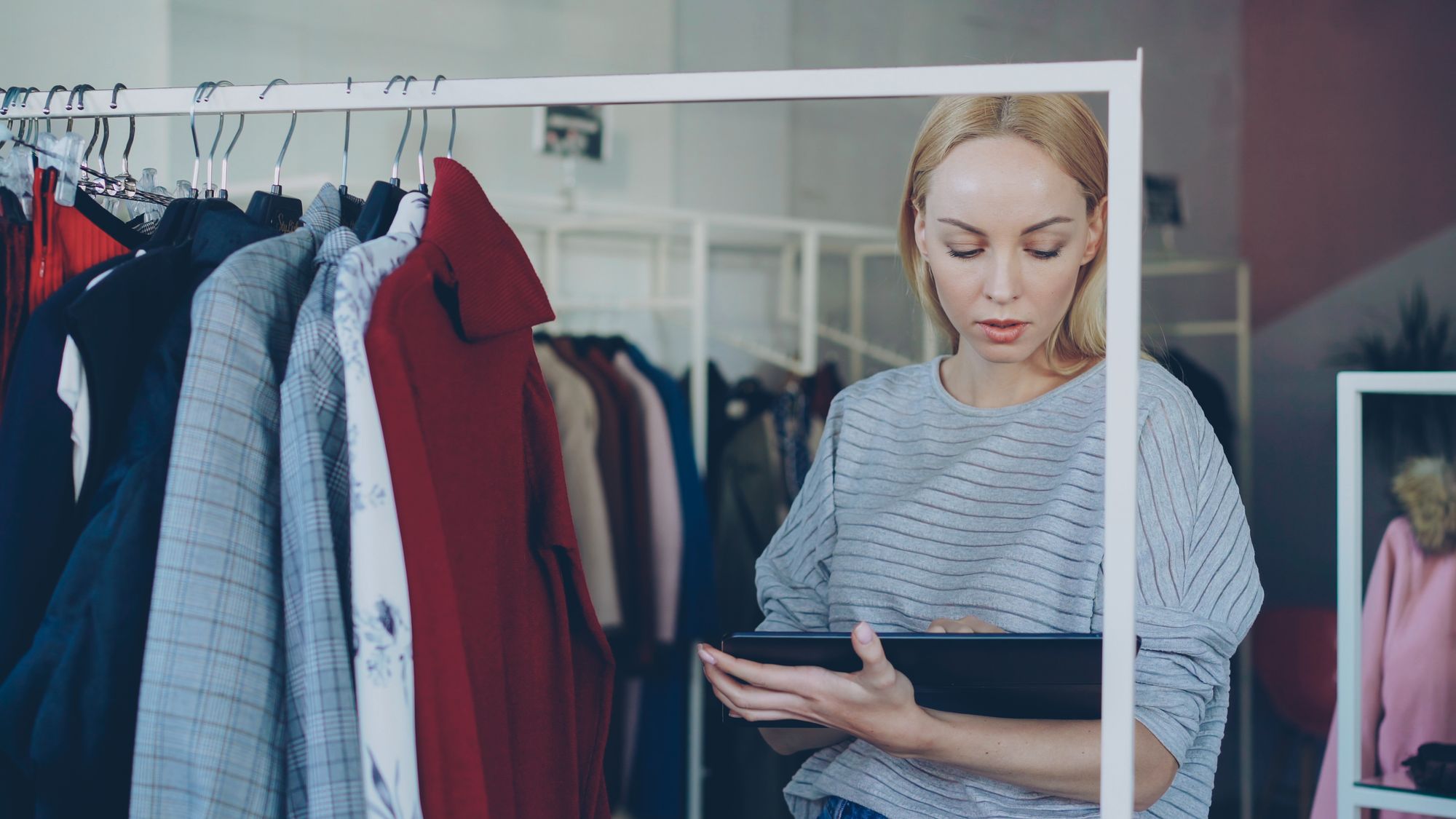 Retail operator checking clothing stock in a shop